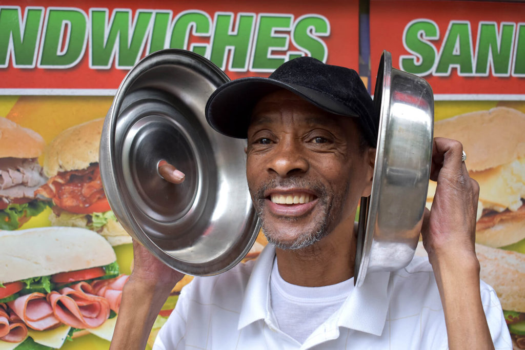 Man with food covers next to his ears