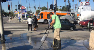 Cleaning the sidewalk