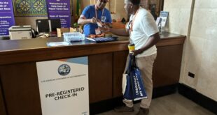 Board Member Nathan Freeman assists with check in