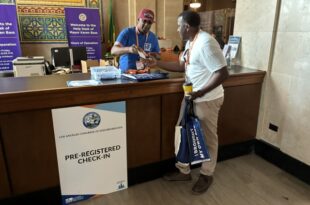 Board Member Nathan Freeman assists with check in